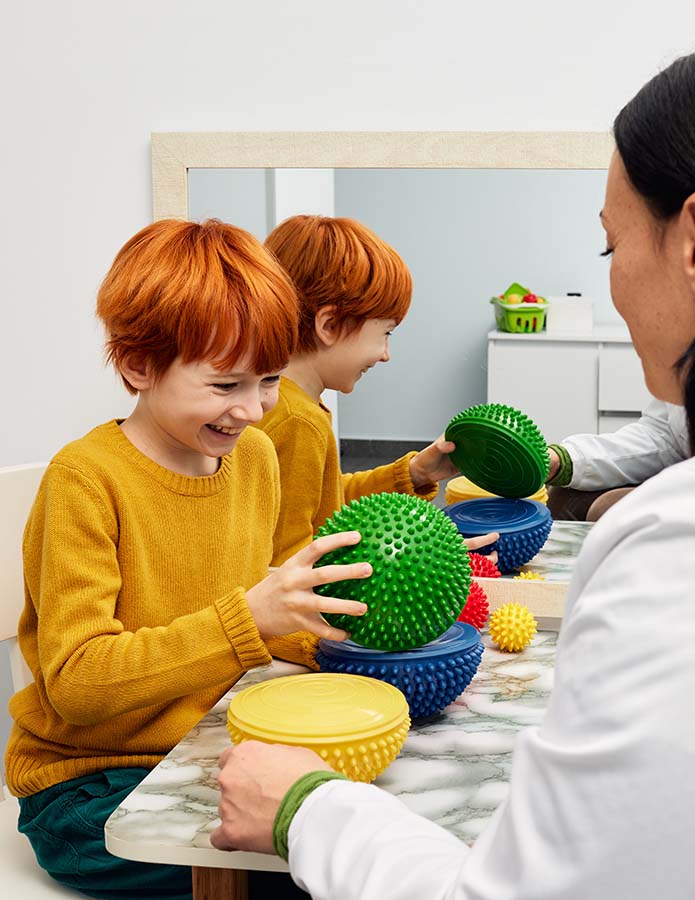 Boy with ASD working with sensory therapist