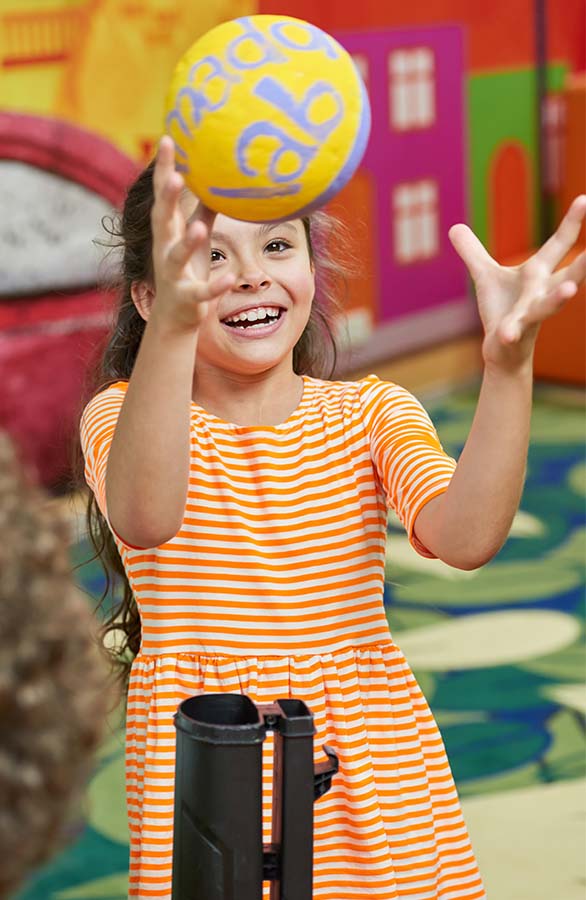 Happy girl catching a ball