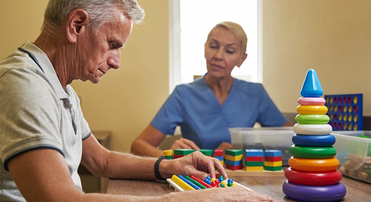 mature patient using physiotherapy equipment